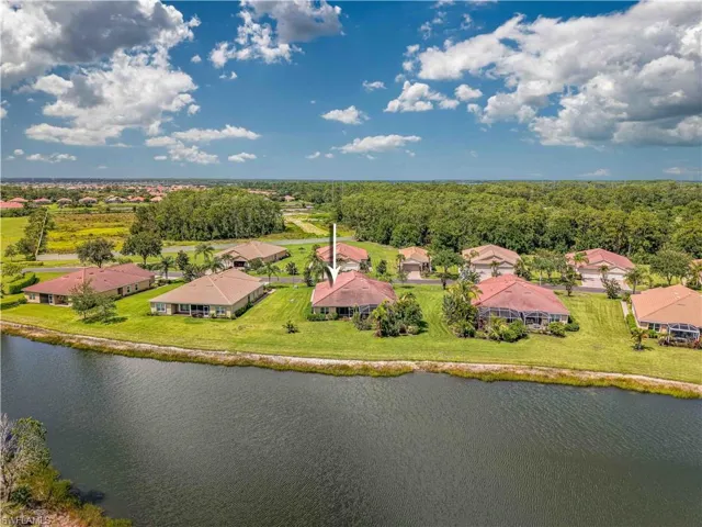 Drone / aerial view of a large body of water and a heavily wooded area
