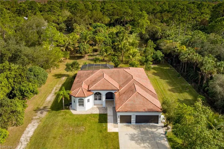 View from above of property featuring a heavily wooded area