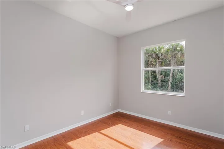 Unfurnished room featuring light wood-style flooring and ceiling fan