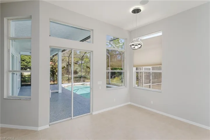 Doorway featuring baseboards and a sunroom