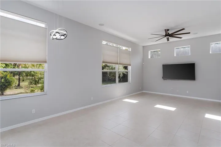 Unfurnished room with ceiling fan and light tile patterned floors