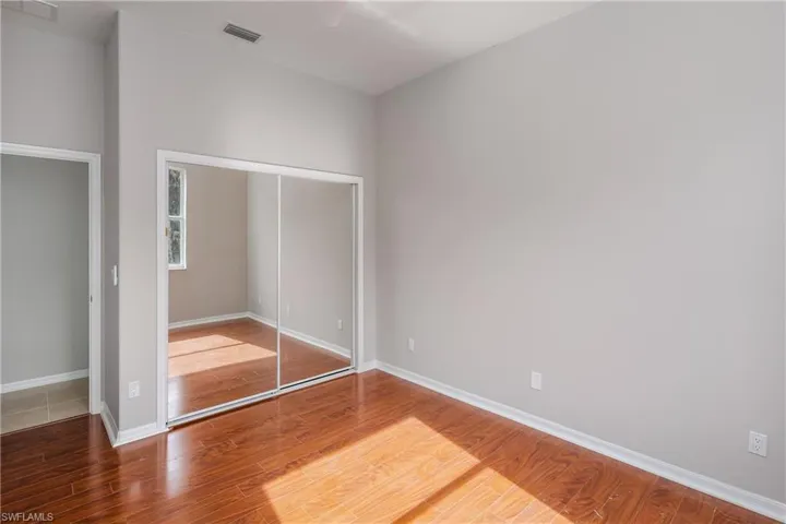 Unfurnished bedroom featuring light wood-type flooring, a closet, and ceiling fan