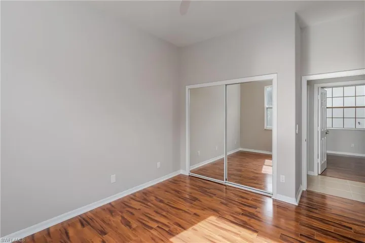 Unfurnished bedroom featuring light wood finished floors, a closet, and ceiling fan
