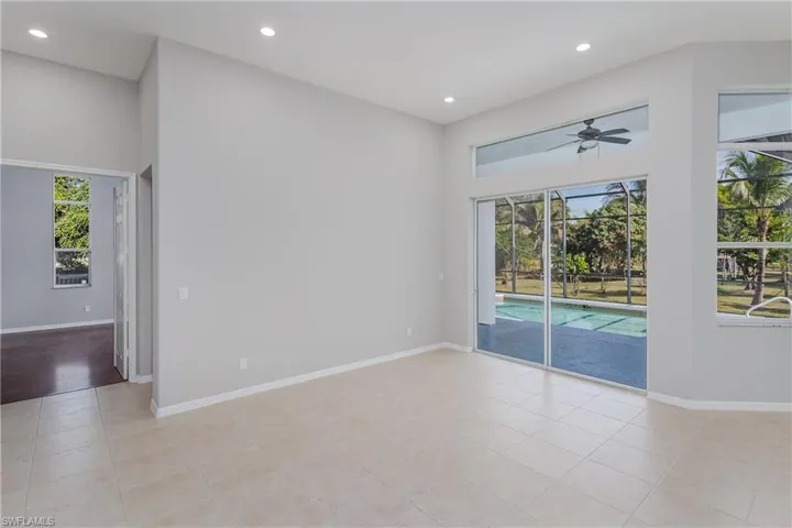 Unfurnished room featuring a sunroom, ceiling fan, recessed lighting, and light tile patterned floors