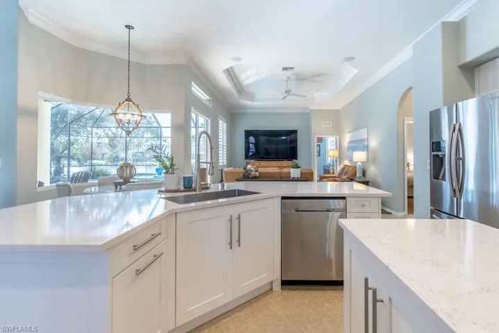 Kitchen featuring white cabinetry, a wealth of natural light, sink, and appliances with stainless steel finishes