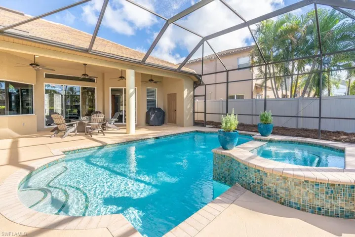 View of pool with a grill, a patio area, ceiling fan, and a lanai