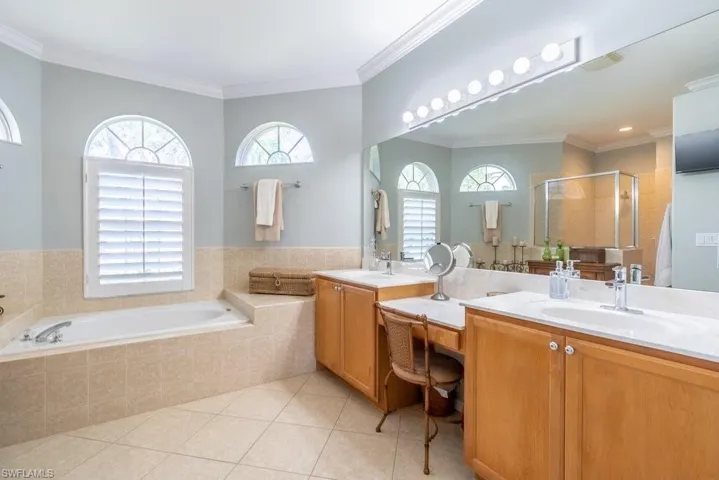 Bathroom with vanity, independent shower and bath, ornamental molding, and tile patterned flooring