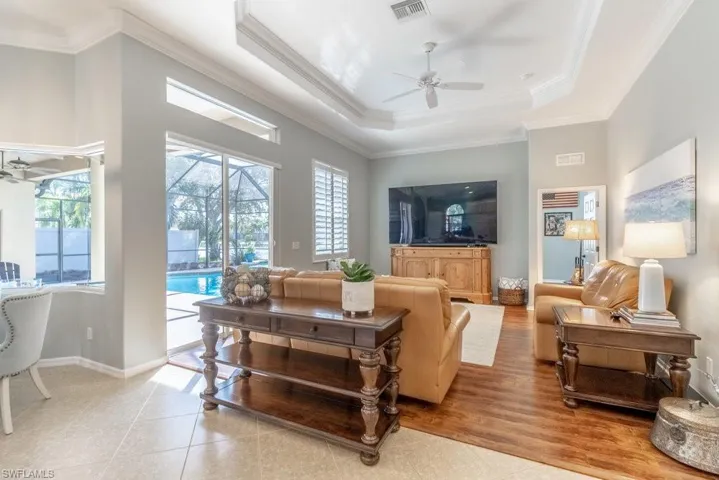 Living room featuring ceiling fan, light hardwood / wood-style floors, and ornamental molding