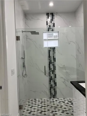 Bathroom with a shower with shower door