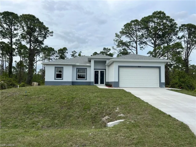View of front facade with a garage and a front yard