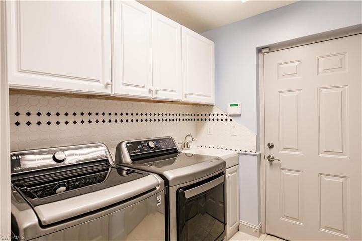 LAUNDRY ROOM WITH HIGH END LG WASHER & DRYER! PLUS WHITE CABINETS, SINK & DECORATIVE TILE BACKSPLASH! HUGE SAVINGS HAVING THESE UPDATED APPLIANCES!