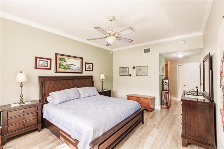 LARGE MASTER BEDROOM WITH NEW WOOD FLOORING, CROWN MOLDING & WITH A "FLORIDIAN LOOK!"