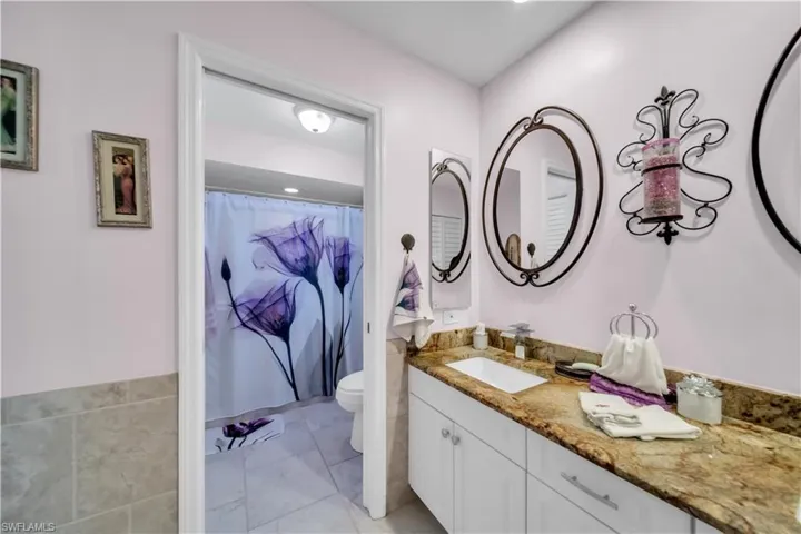 Bathroom with curtained shower and vanity