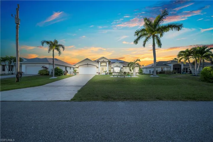 Ranch-style house featuring driveway, a lawn, and a residential view