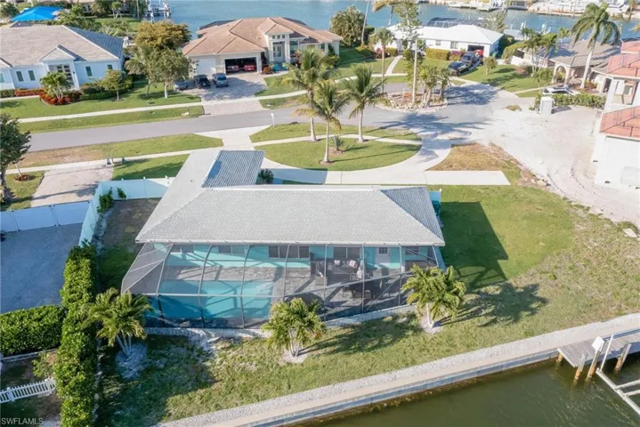 Birds eye view of property with a residential view and a water view