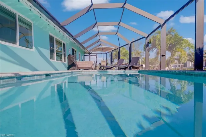 Outdoor pool with a lanai and a patio