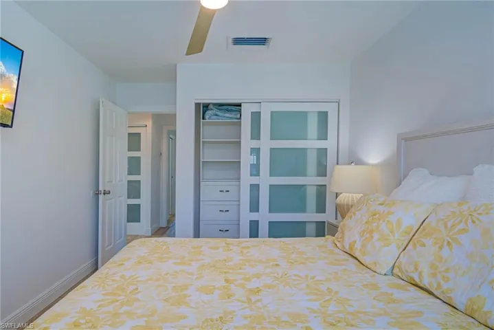 Bedroom with a ceiling fan, baseboards, a closet, and visible vents