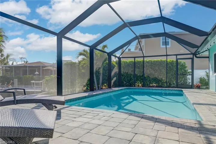 Pool with a lanai and a patio area