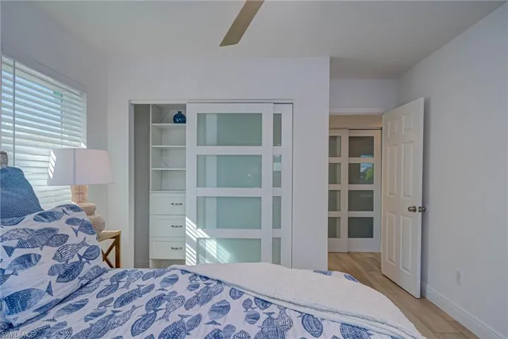 Bedroom with baseboards, ceiling fan, and wood finished floors