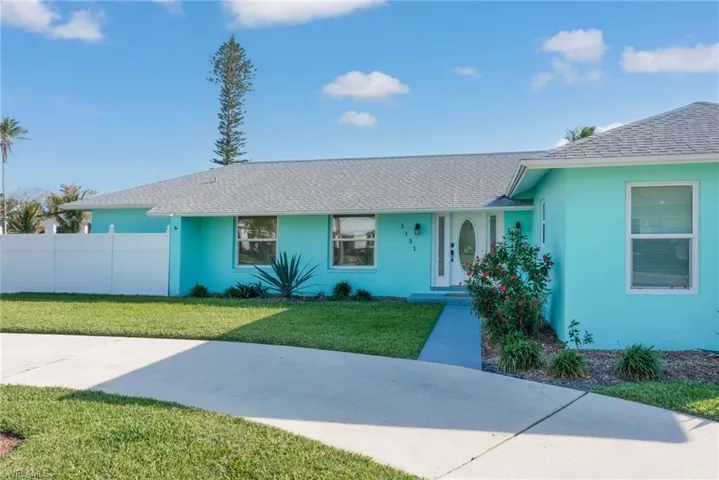 Single story home featuring a front yard and fence