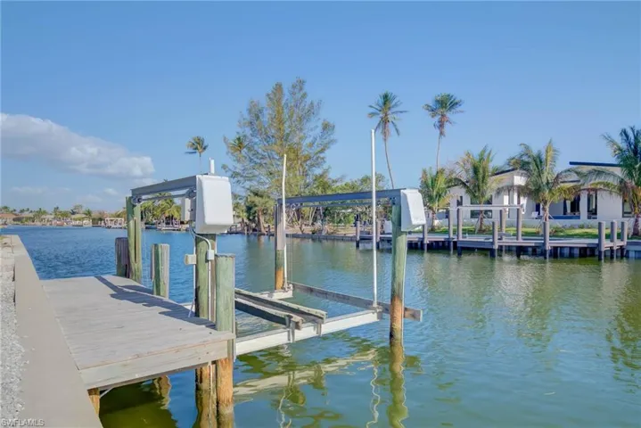Dock area featuring a water view and boat lift