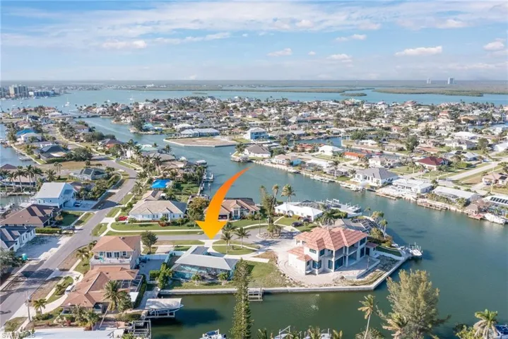 Birds eye view of property with a residential view and a water view