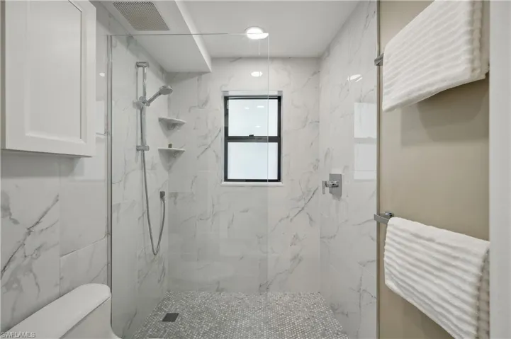 Bathroom with a tile shower and toilet