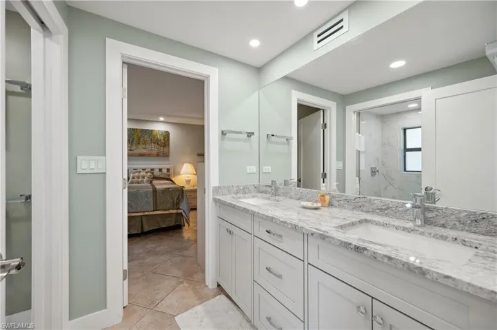Bathroom with dual vanity and tile floors