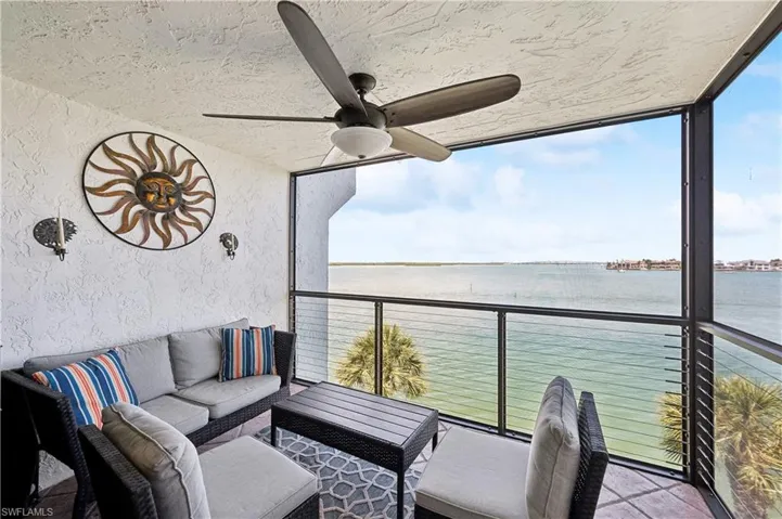 Sunroom with a water view and ceiling fan