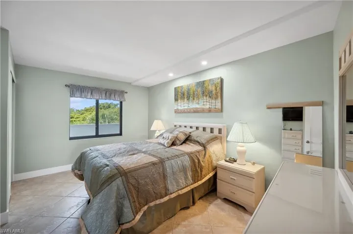 Bedroom with light tile flooring