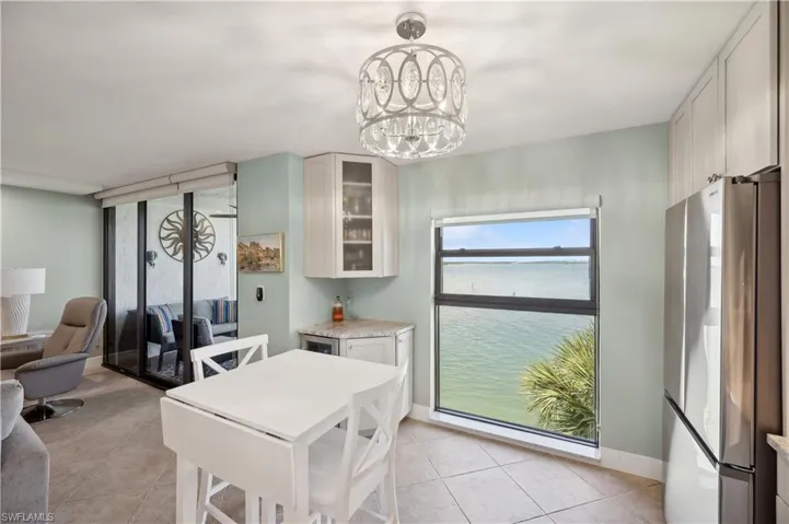 Dining area with a notable chandelier and light tile floors