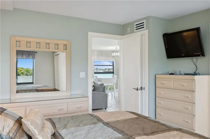 Bedroom featuring light tile floors and a chandelier