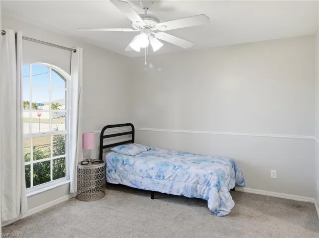 Bedroom 1 featuring carpet and ceiling fan
