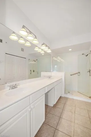 Dual vanity with integrated sinks, expansive counter space, and lower cabinetry