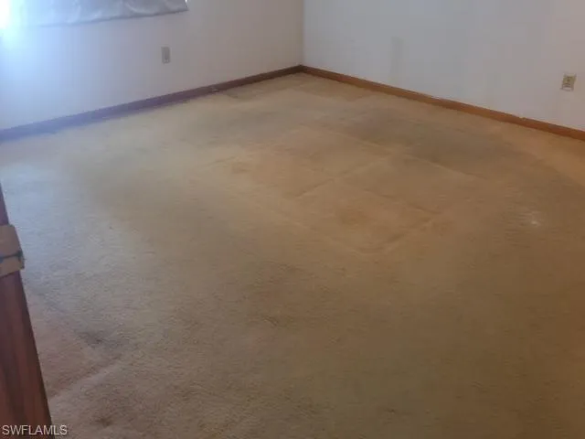 Unfurnished room featuring carpet
