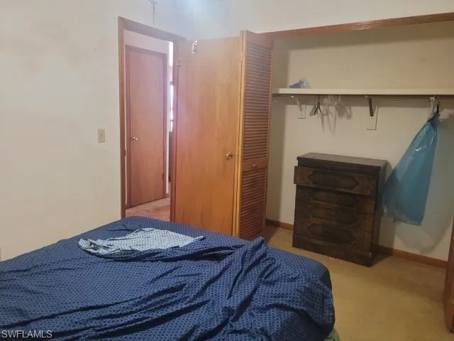 Bedroom featuring a closet and carpet flooring