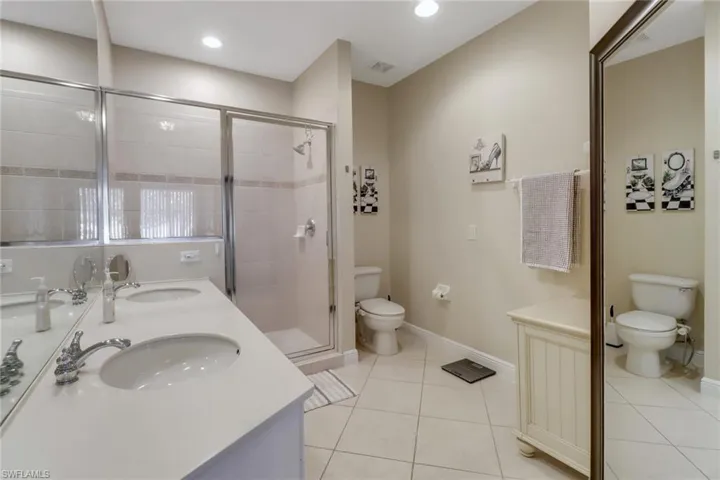 Primary bath features an oversized shower and dual sinks.