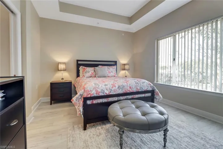 The primary room with accented tray ceilings and expansive windows allow the natural light in to highlight the openness of cozy this retreat. (THE MASTER FURNISHINGS WILL BE DIFFERENT THAN SHOWN IN THIS PICTURE)