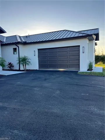 Garage with asphalt driveway