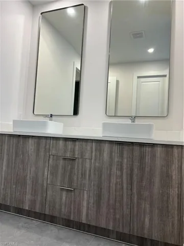 Bathroom with double vanity and recessed lighting
