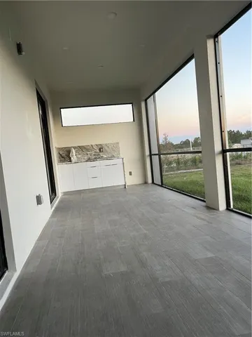 Unfurnished sunroom featuring plenty of natural light