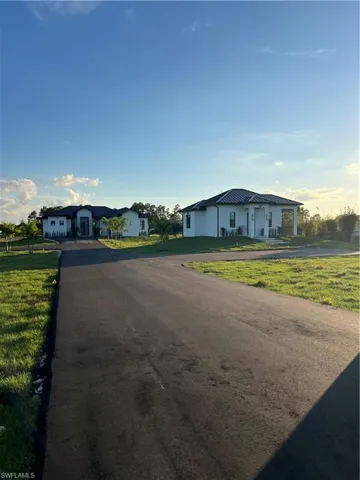 Ranch-style home featuring a front lawn and a residential view