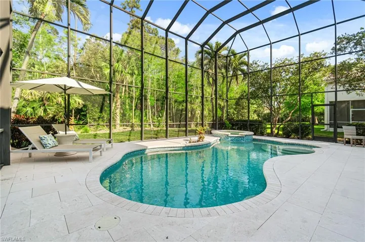 Miami chic Shellstone pool area, enclosed with a grand two-story cage and shaded dining and kitchen opportunity. Quiet preserve view.