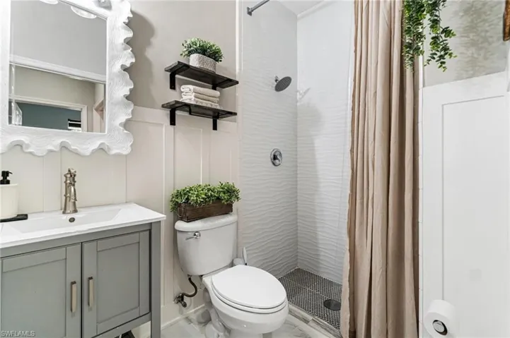 Full bath downstairs was completely updated with new vanity, flooring, modern fixtures and all new tile, decorative molding, and a custom designer feel.