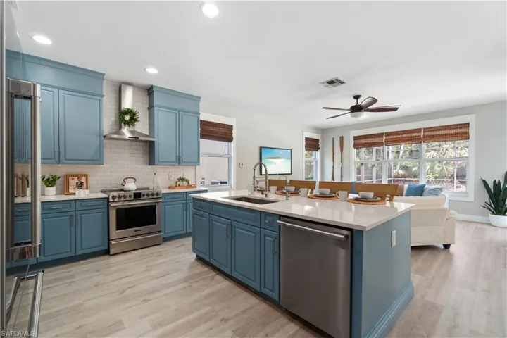 enovated kitchen included re orienting the island, expanding and modernizing to counter level.