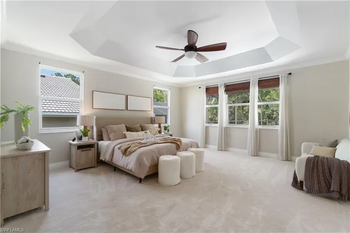 Expansive primary en-suite is 17’x16’ with beautiful tray ceiling detail.