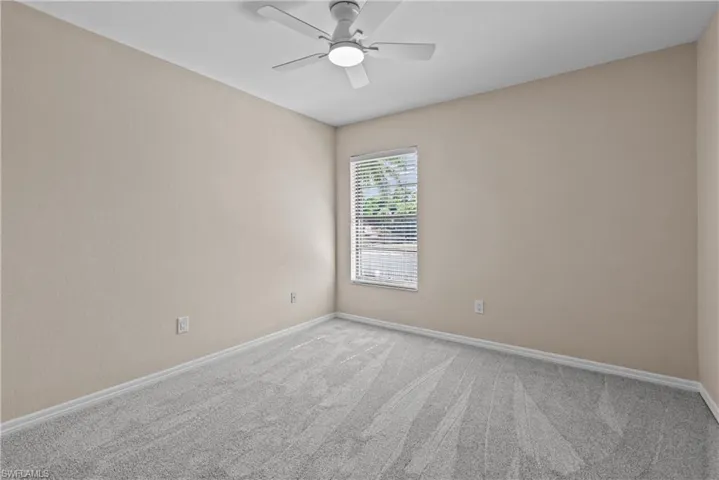Empty room with carpet flooring and ceiling fan
