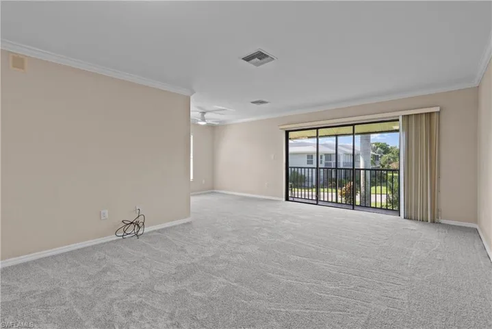 Carpeted empty room with crown molding and ceiling fan