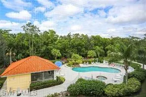 Community pool featuring a patio area and a hot tub