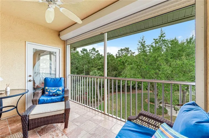 Sunroom featuring a ceiling fan